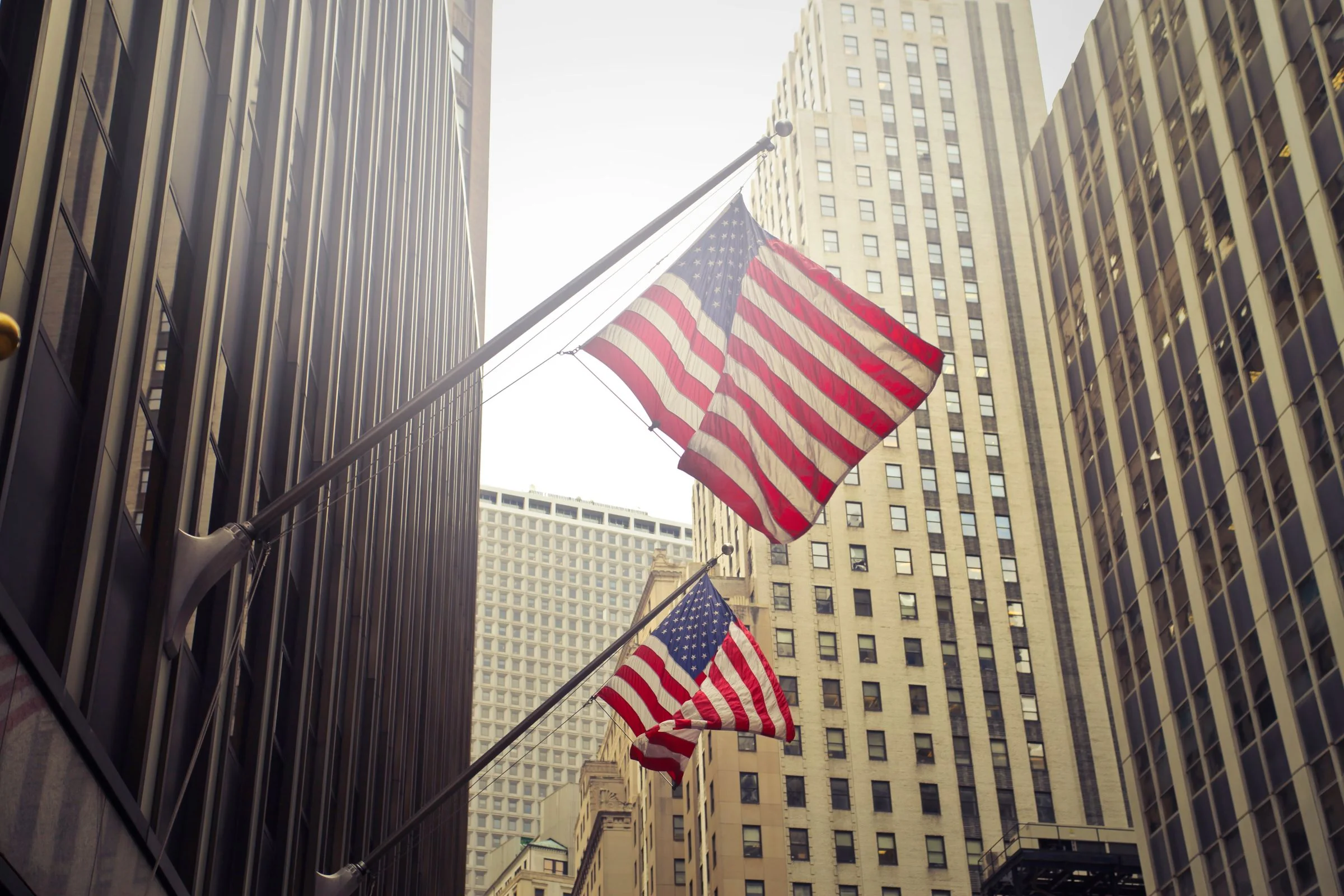 American flags flying from a city building
