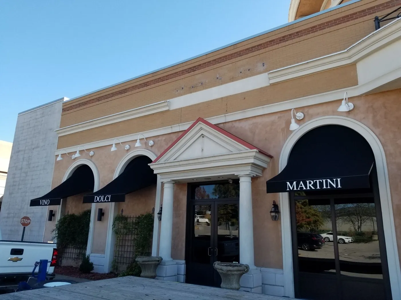 A building with a black awning that says martini