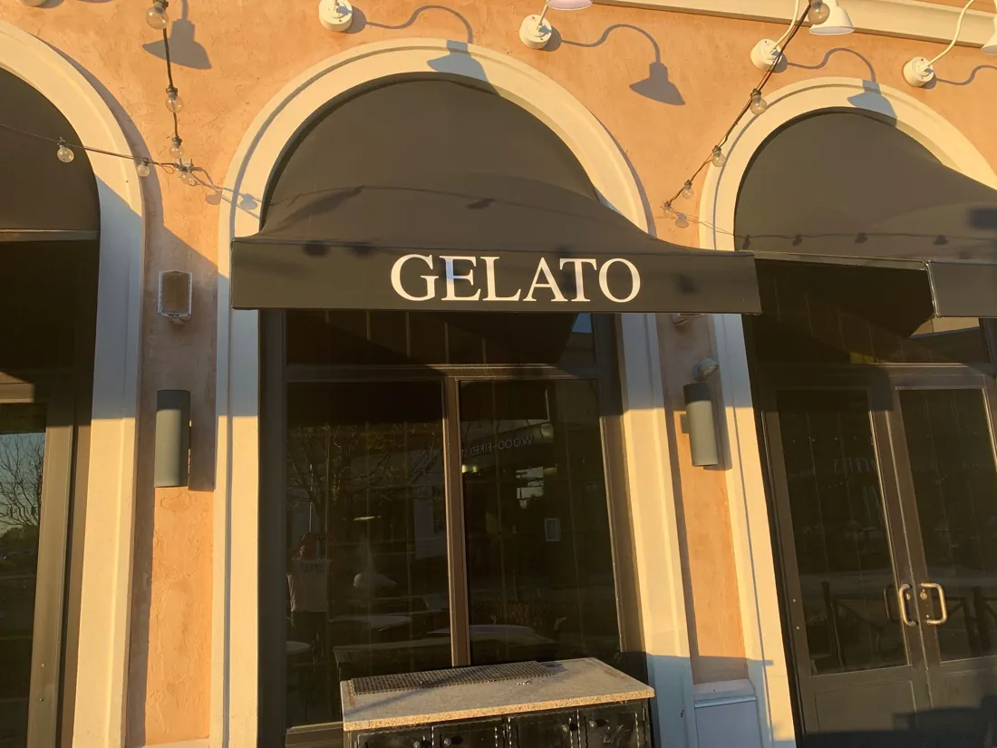 Branded awnings shading a row of restaurant windows