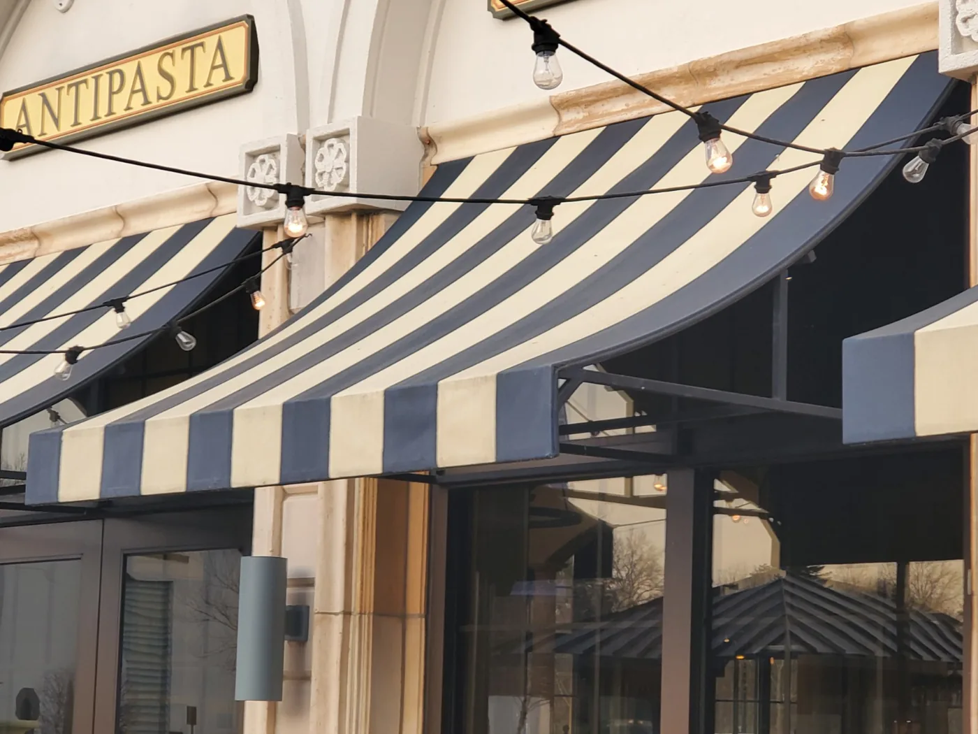Striped awnings over a Brio restaurant entrance