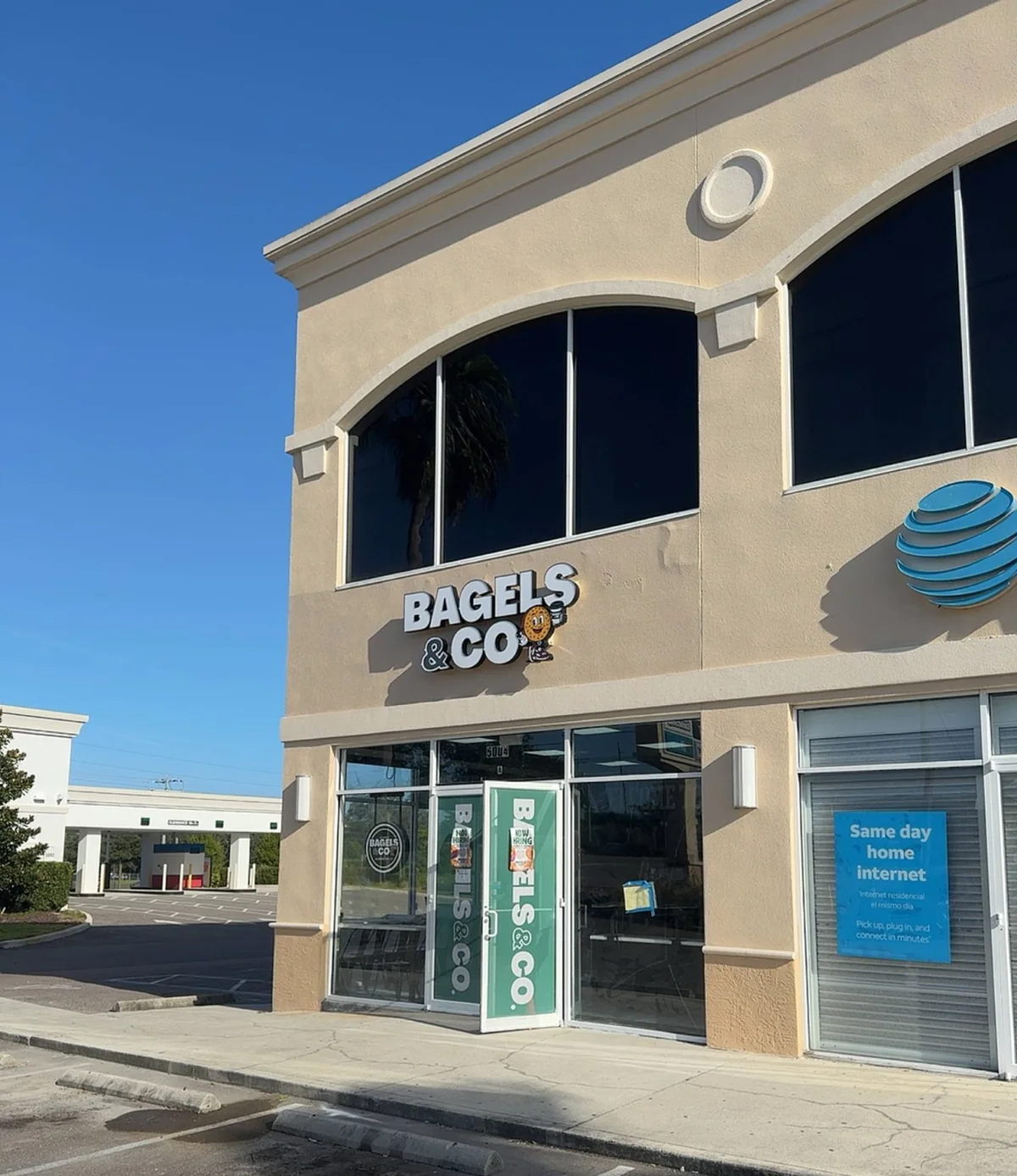 The Bagels & Co facade sign seen from the parking lot with the AT&T tenant beside it