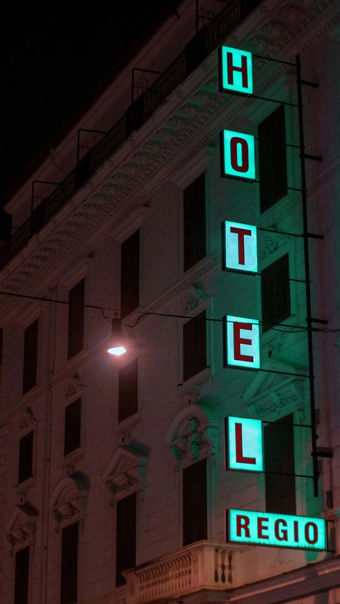 A tall illuminated hotel sign lit at night