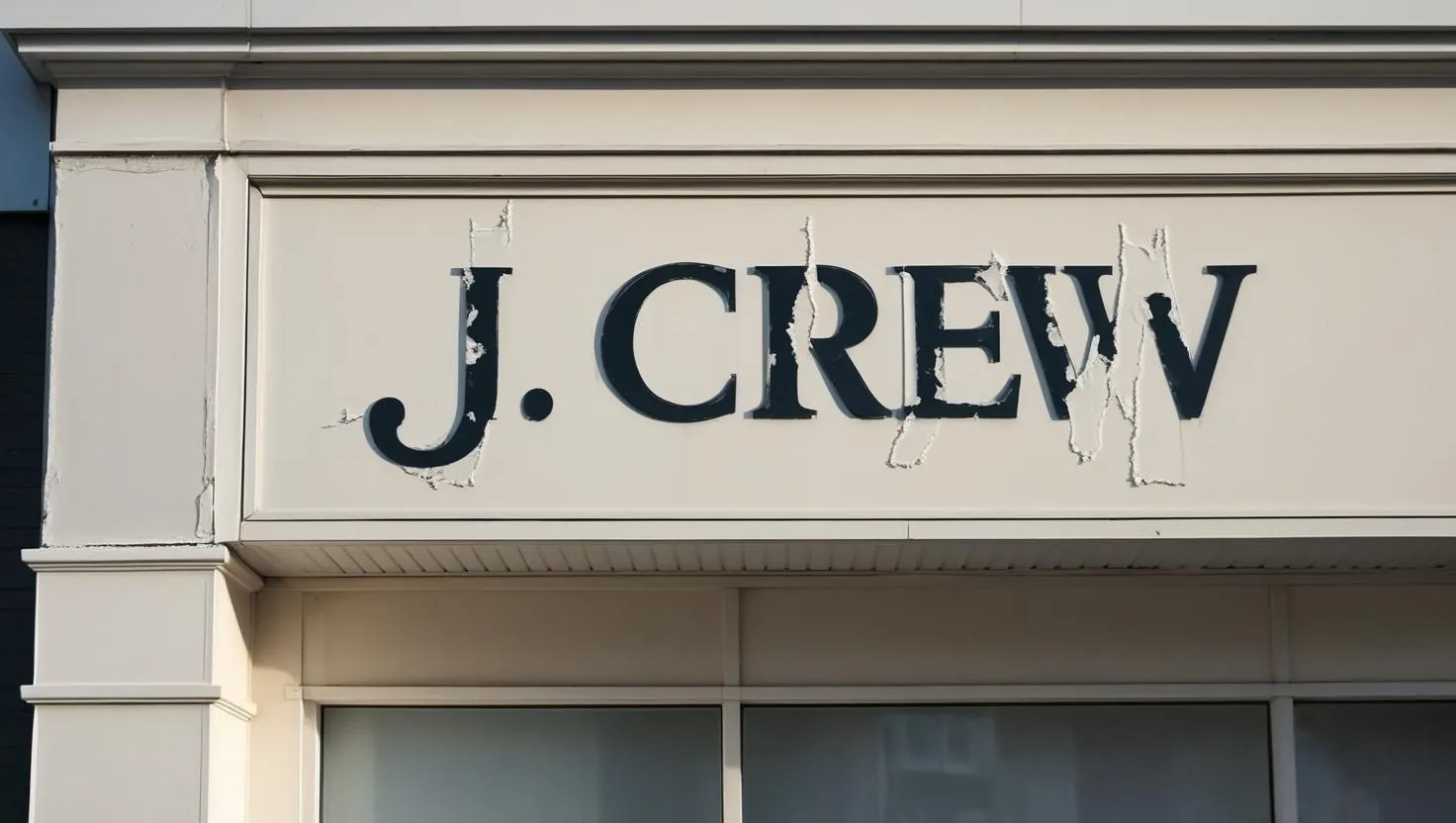 A storefront facade where a removed sign has left a faded outline behind