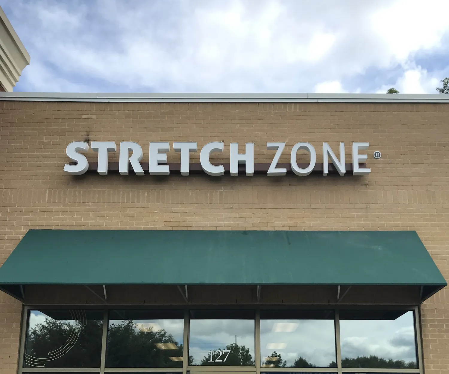 Stretch Zone storefront signage on a multi tenant building