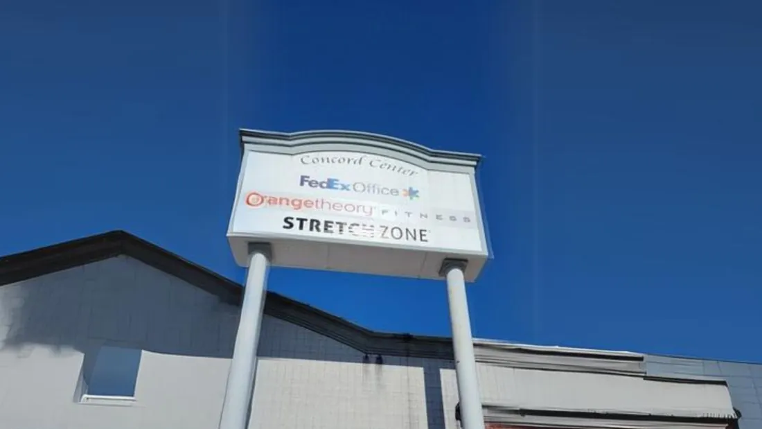 A pylon sign standing above a retail site