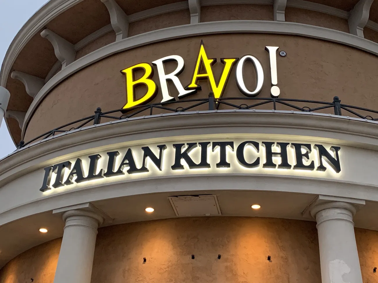 Illuminated channel letters lit at night on a restaurant storefront