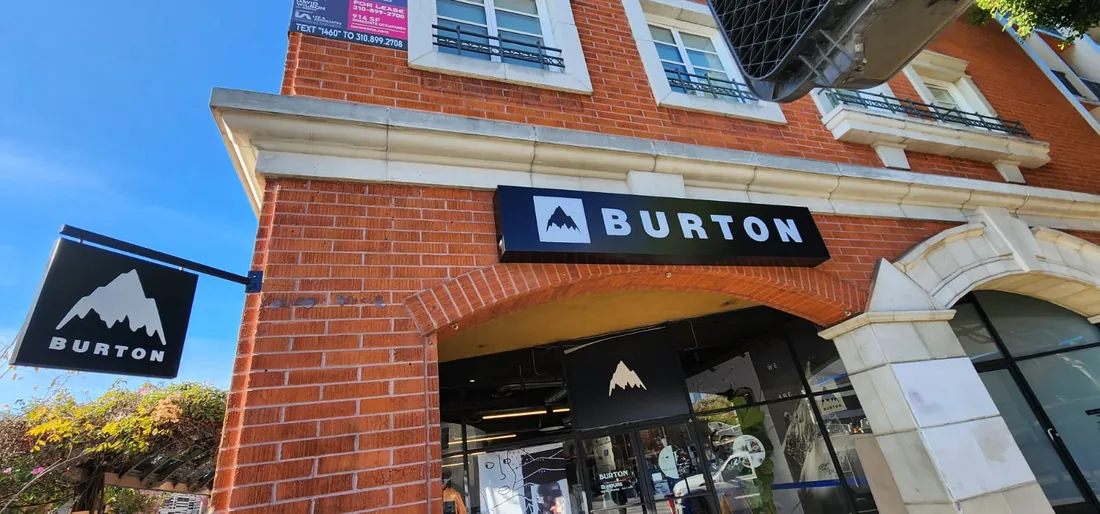 A projecting blade sign mounted perpendicular to the facade