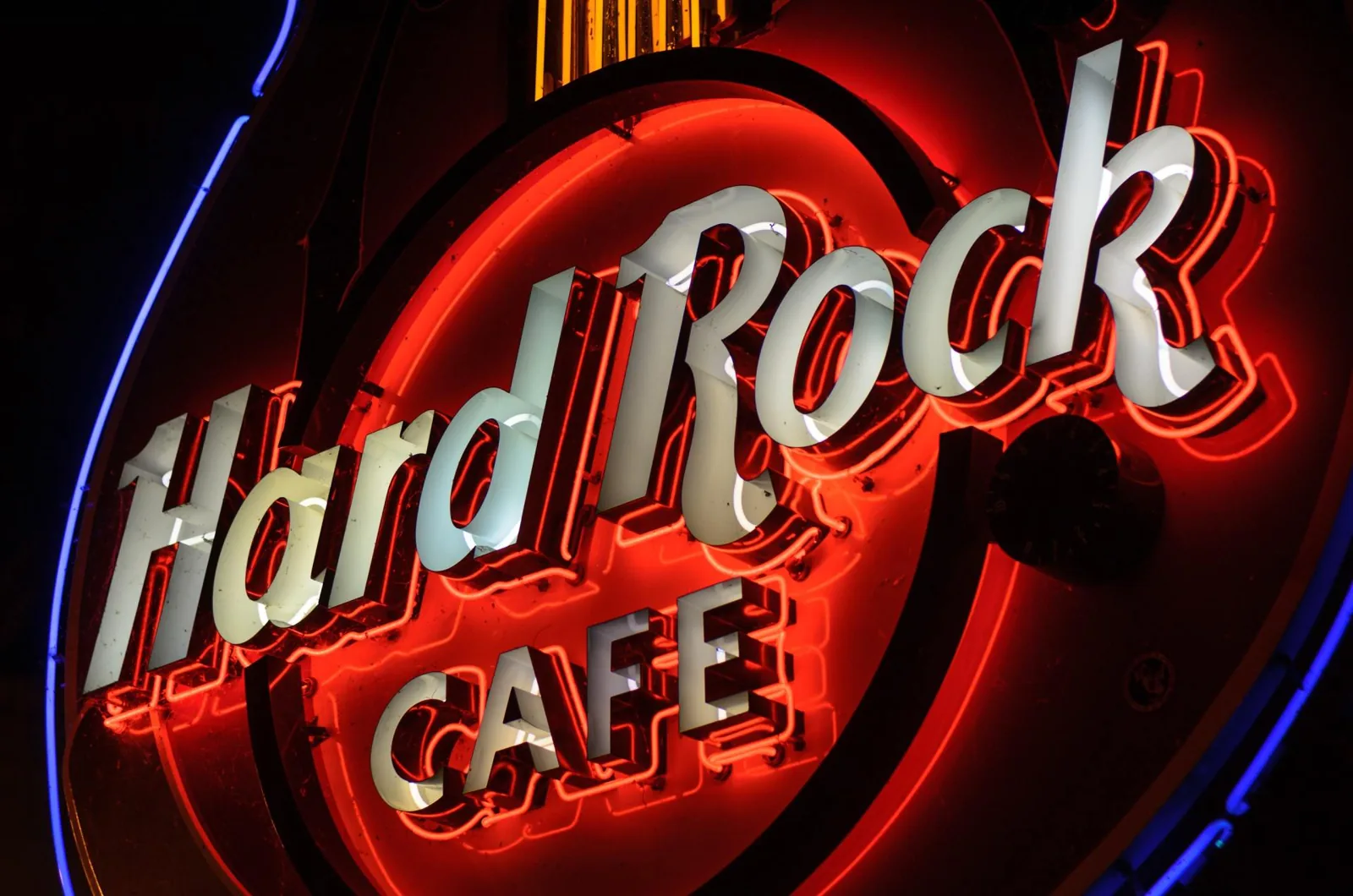 A Hard Rock Cafe sign in red exposed glass tube neon with a blue neon border