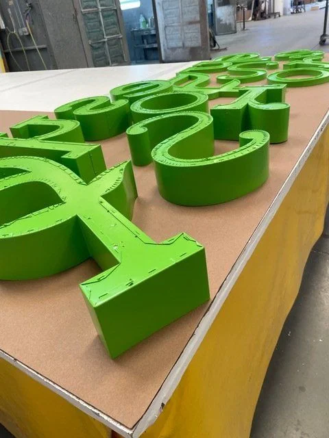 A fabricated illuminated storefront sign by National Sign Team