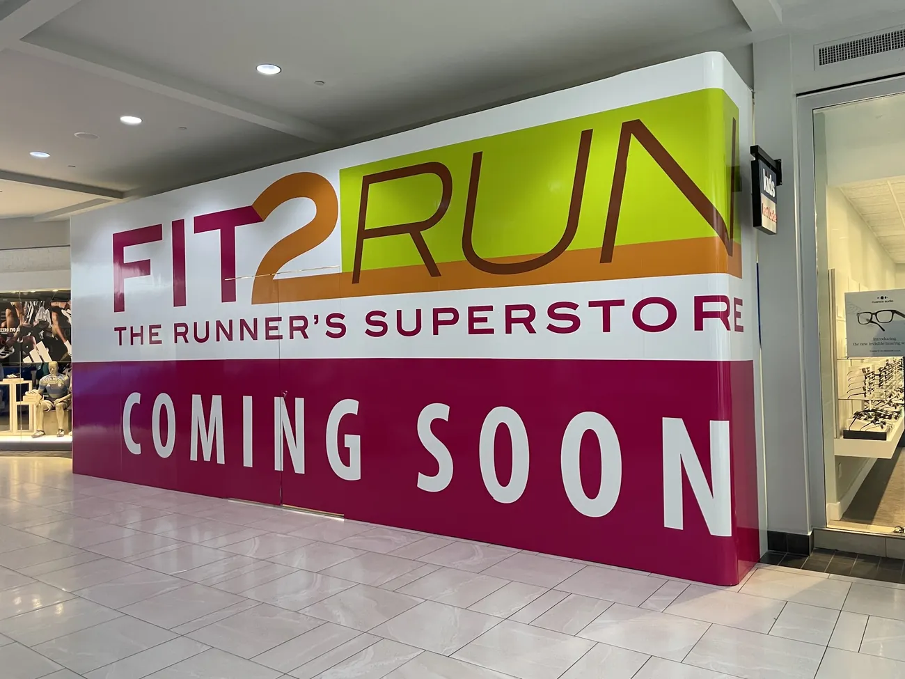 Barricade graphics wrapping a retail buildout during construction