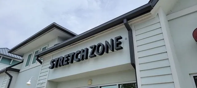 A stretch zone sign is on the side of a building